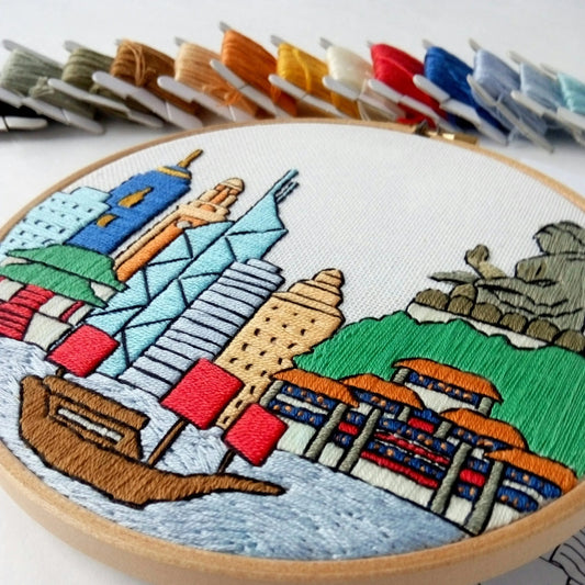 Colorful hand embroidery of Hong Kong cityscape in a wooden hoop
