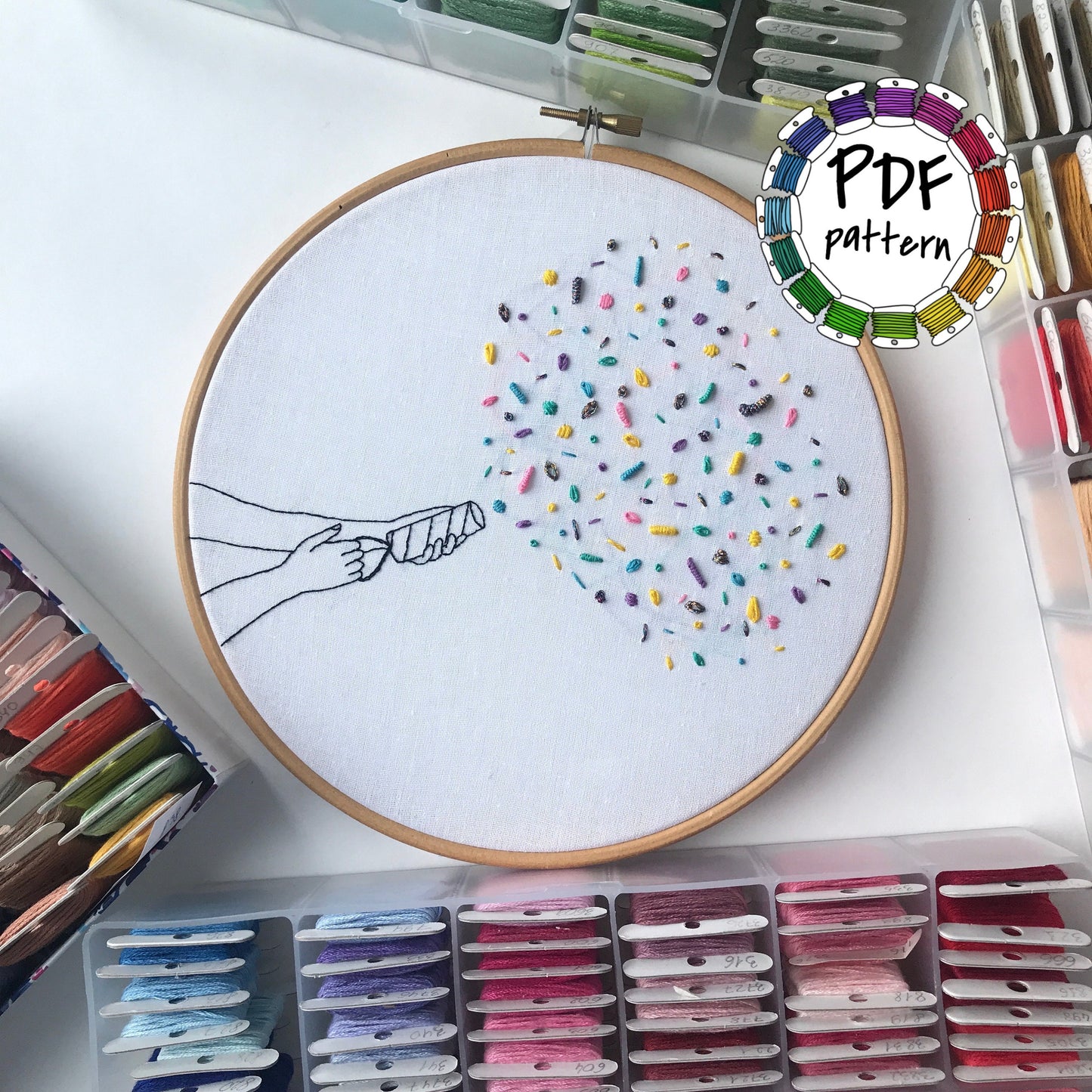 Party Popper hand embroidery pattern PDF with colorful stitches in a hoop.