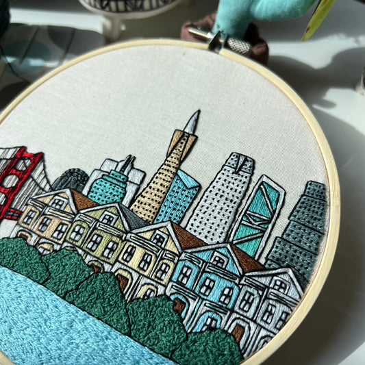 Hand embroidery of San Francisco skyline in a wooden hoop