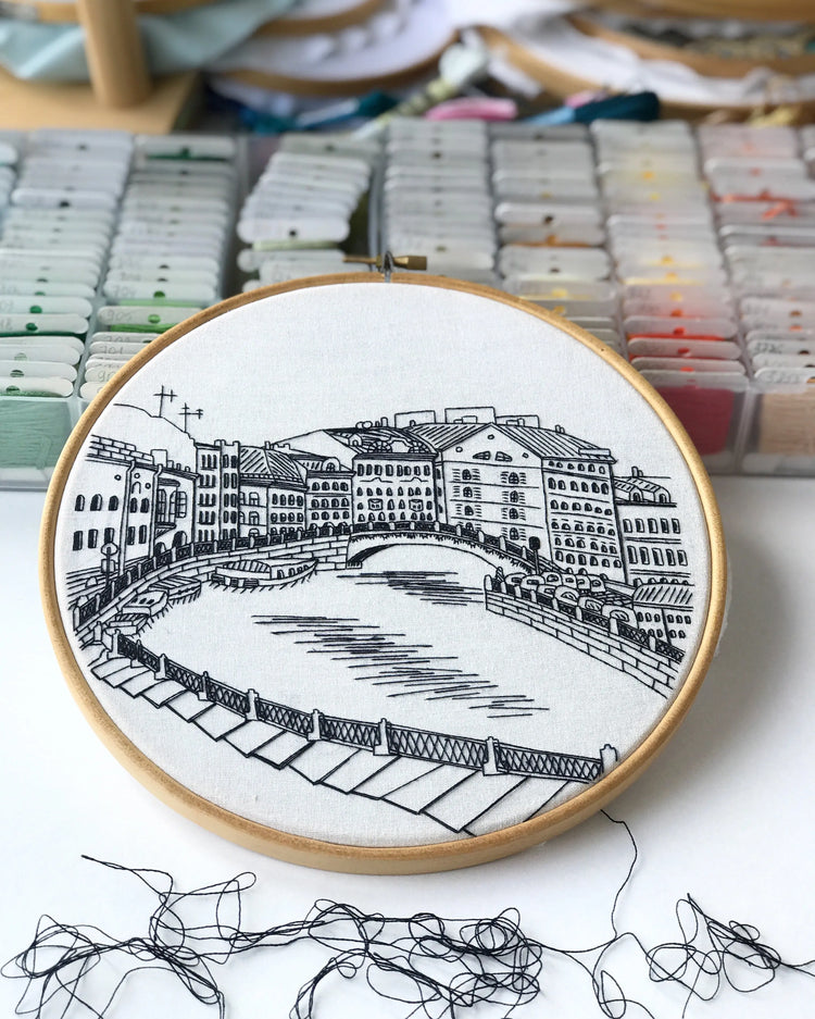 Architectural embroidery pattern featuring detailed building and structure designs