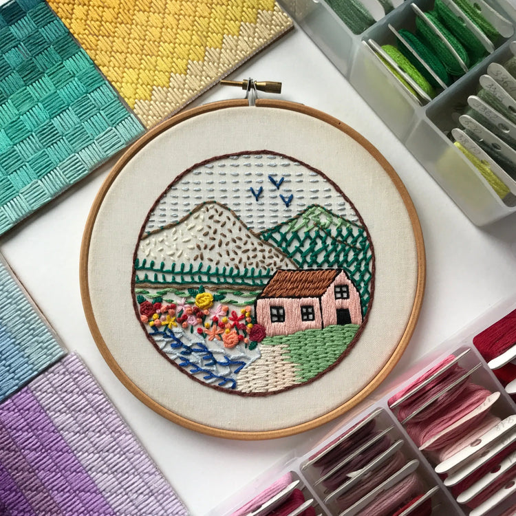 Simple beginner-friendly embroidery pattern displayed in wooden hoop for new stitchers