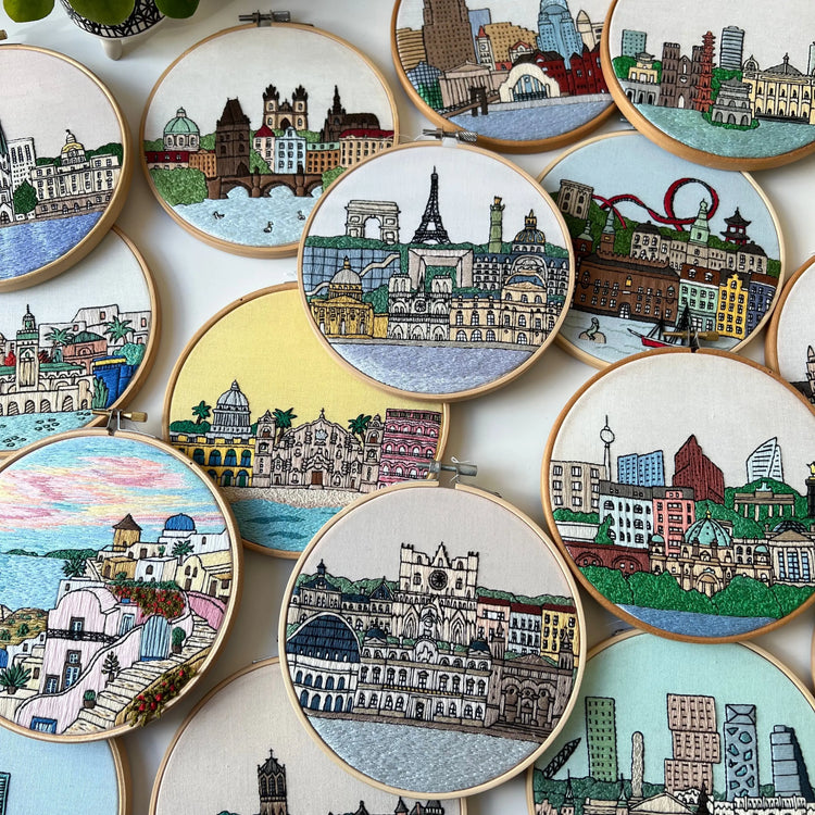 Hand-stitched cityscape embroidery patterns featuring architectural buildings in hoop